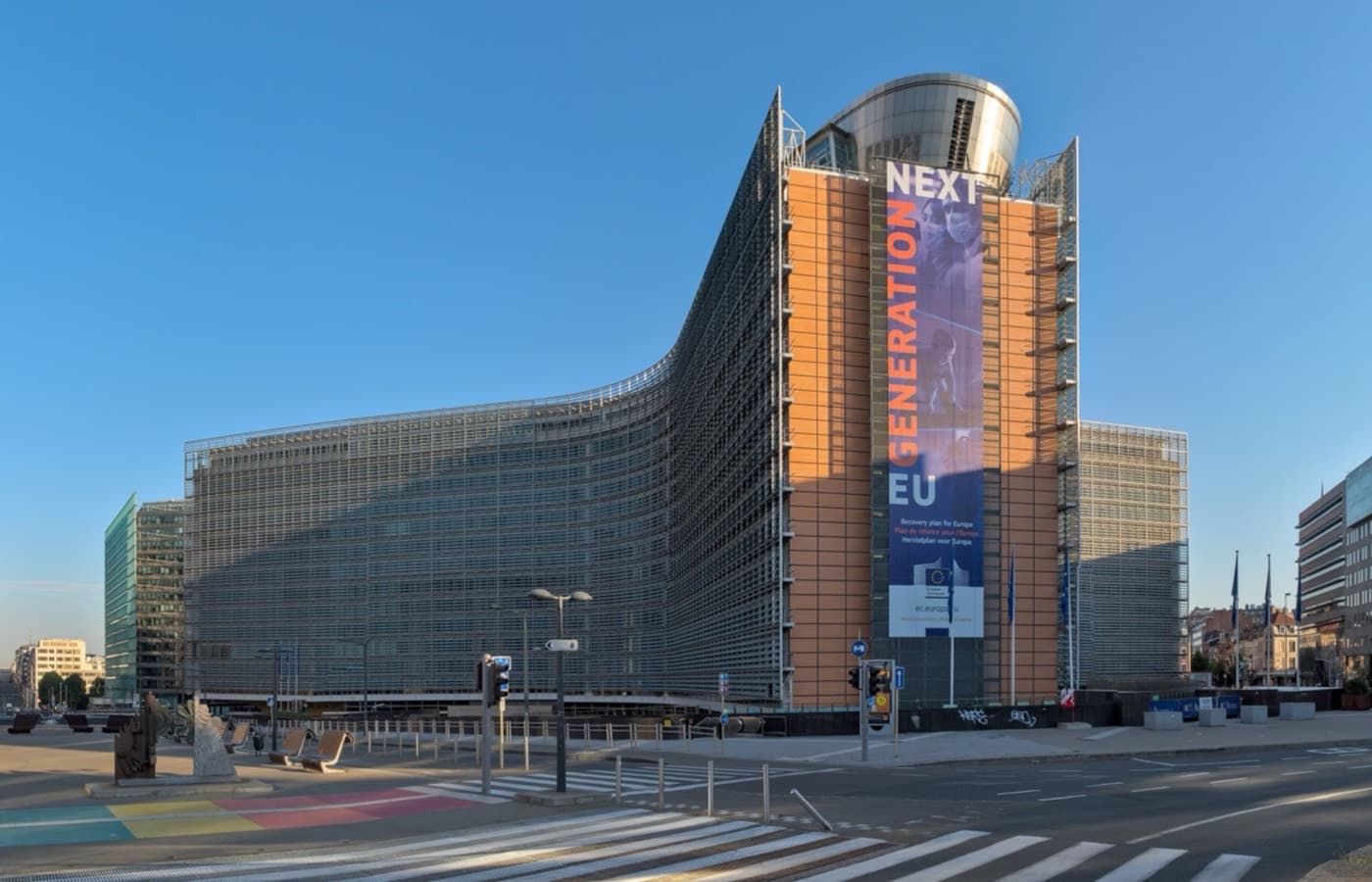 The European Commission headquarters in Brussels, its glass wings curving along the street.